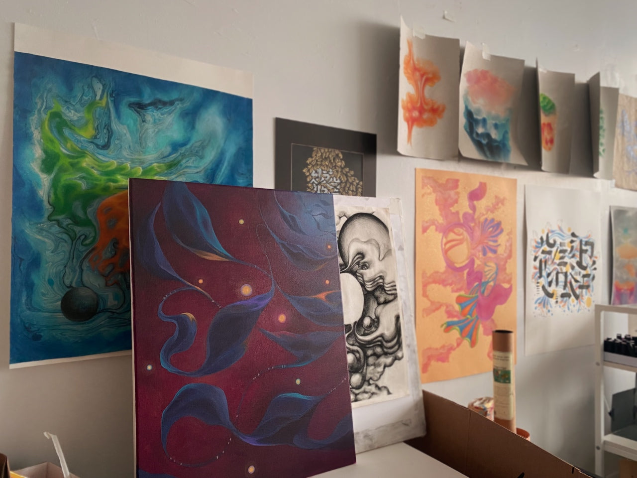 artwork lining the wall of my studio